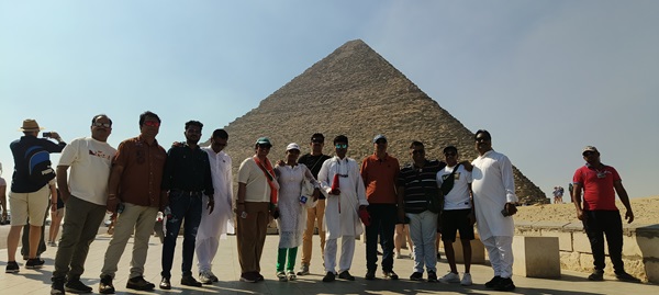 A group posing in front of the Valley of the Kings entrance