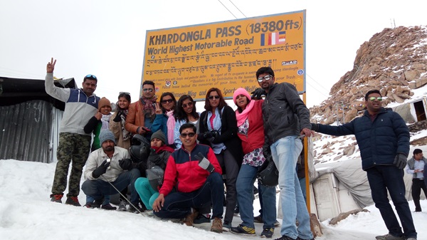 A group of travelers enjoying the view from Khardung La Pass