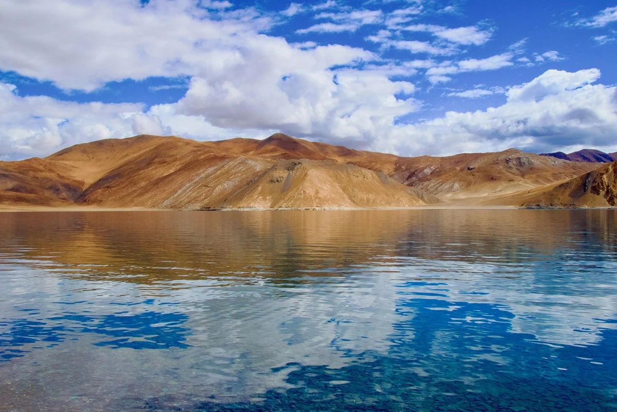 Pangong Tso Lake, with its stunning blue waters and barren mountains