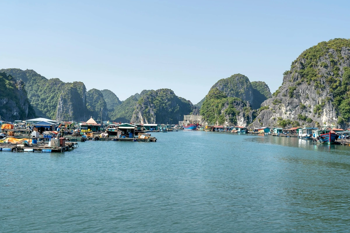 Ha Long Bay with limestone islands and a traditional boat