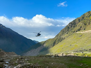 A helicopter flying over the mountains