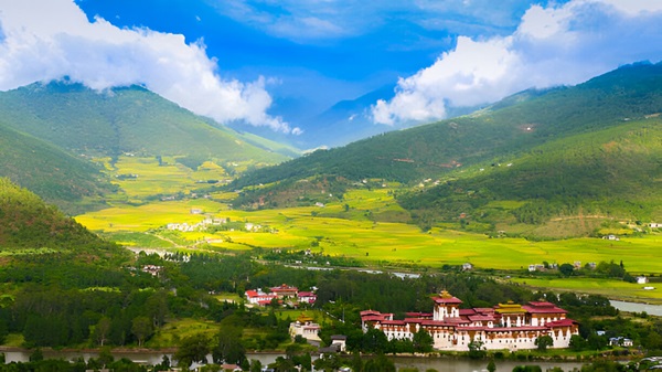 A beautiful view of mountains and a fortress in Bhutan